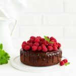 Deliciously decorated carrot cake topped with cream cheese frosting and carrot garnish