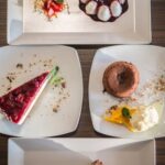 Various cake decorating tools including piping bags, fondant smoother, spatulas, and cake stencils