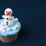 Festive holiday cakes adorned with decorative Christmas elements such as snowflakes, ornaments, and holly
