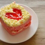 Can You Use Whip Cream to Decorate a Cake Sliced cake topped with dollops of whip cream used as decorative frosting