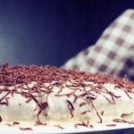 How to Decorate a Store Bought Chocolate Cake Sliced store bought chocolate cake adorned with piped frosting and decorative sprinkles