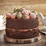 Strawberry Cake Decorations Colorful strawberry-shaped cake decorations arranged on top of a fresh cream cake