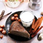 How to Decorate a Naked Cake Naked cake on a rustic wooden stand with fresh fruits and floral decorations