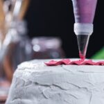 How to Decorate a Carrot Cake for Easter Easter-themed carrot cake with pastel-colored icing and festive chocolate bunny decorations