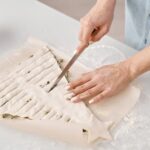 Step-by-step guide on how to decorate Frozen cake with edible snowflakes and icy blue frosting