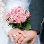 Man in suit raising glass for wedding toast, expressing gratitude and congratulations