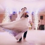 A sleek A-line satin wedding dress with delicate lace detailing and a flattering silhouette