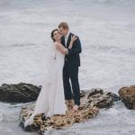 'A couple at the altar exchanging wedding vows.'
