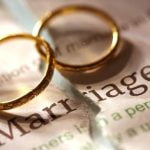 Pair engagement ring and wedding band on left ring finger