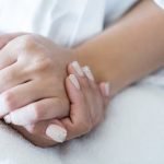 Image of a beautiful wedding, with the bride and groom standing in front of a scenic background
