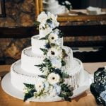 A stunning A-line off-the-shoulder wedding dress with lace detailing and a sweeping train